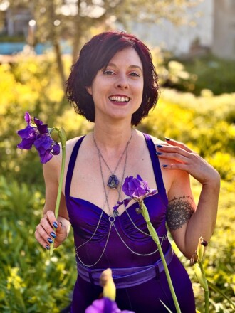 Erotic muse, Sephira, outdoors holding flowers, sensually awakened.