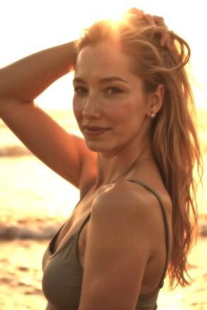 Kami at Tantric Life, Kensington: warm hued sunny headshot hand raised touching head