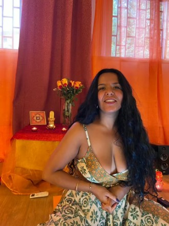 candid shot of Lisbon femininity coach Bhogananda, smiling, wearing dress